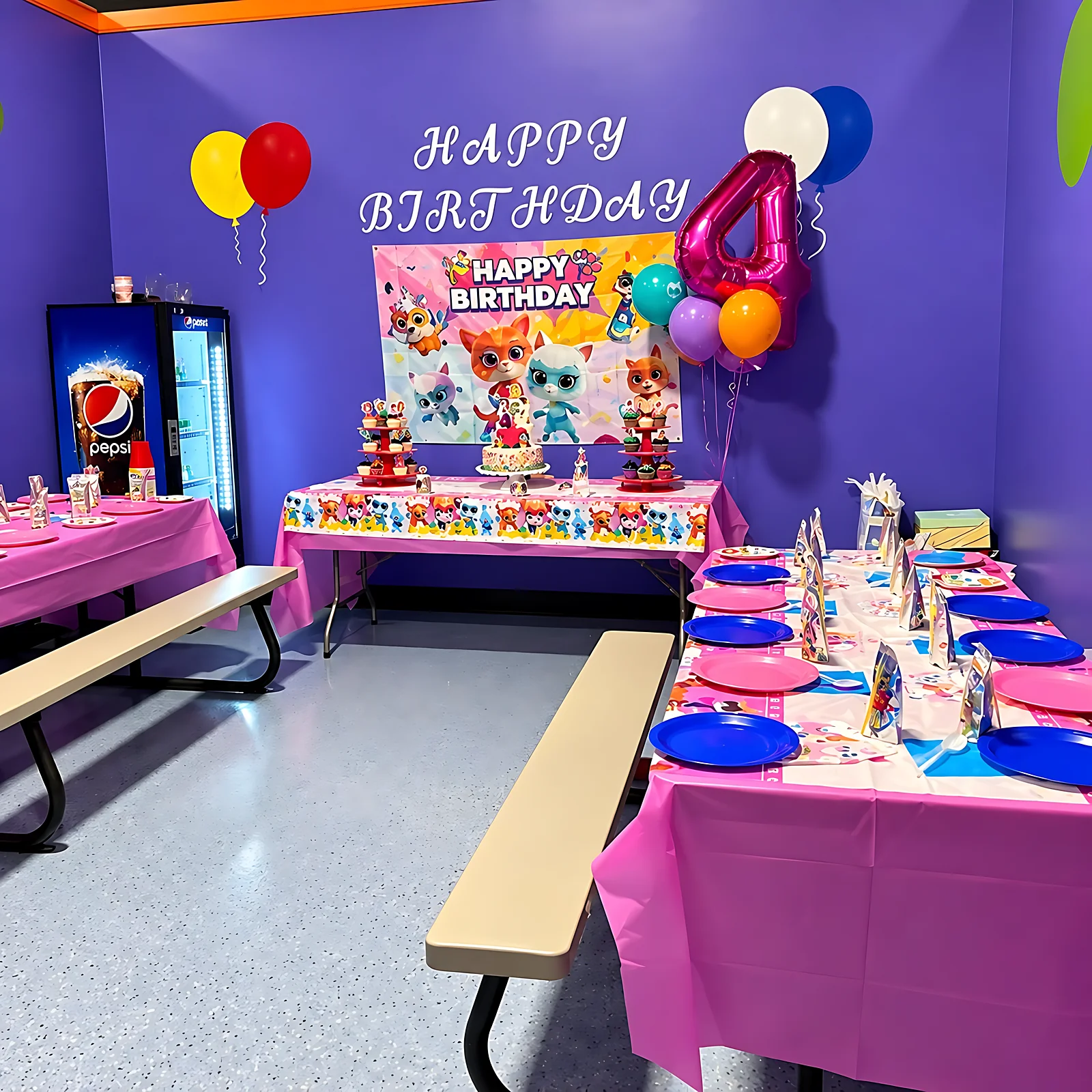 Decorated birthday party table with Happy Birthday banner and balloons